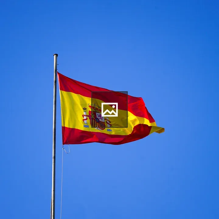 Spanish flag over blue sky