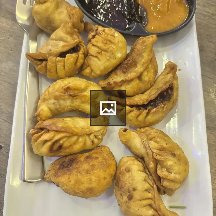 Plate of dumplings with sauces
