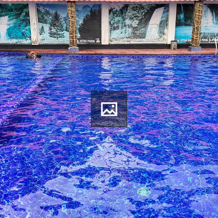 Blue swimming pool with tile steps