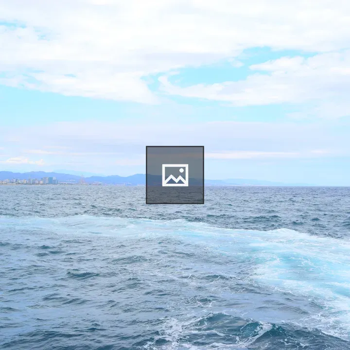 Wide sea with distant city skyline