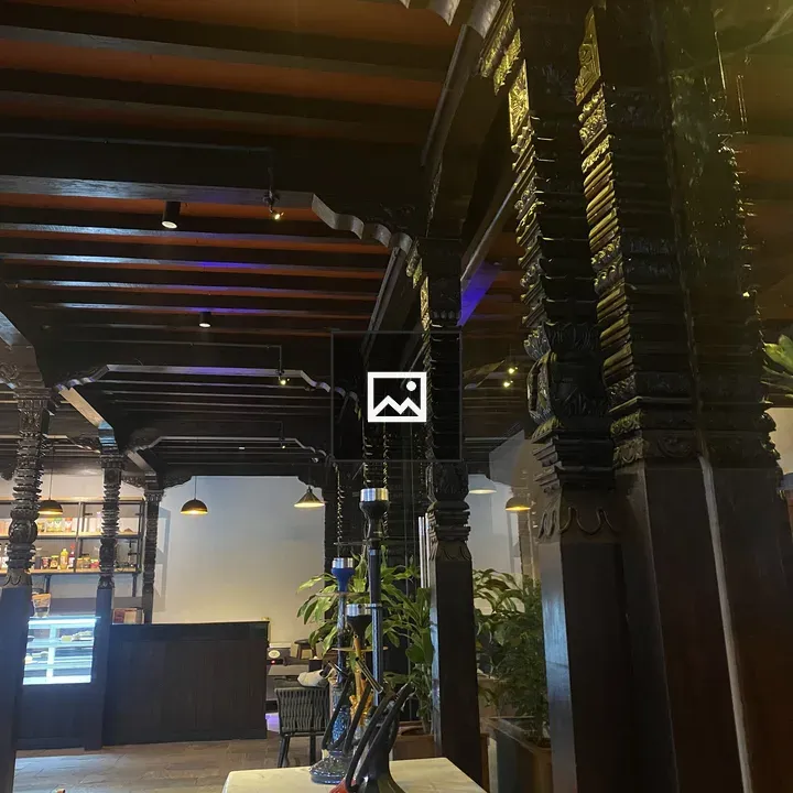 Cozy restaurant interior with carved pillars