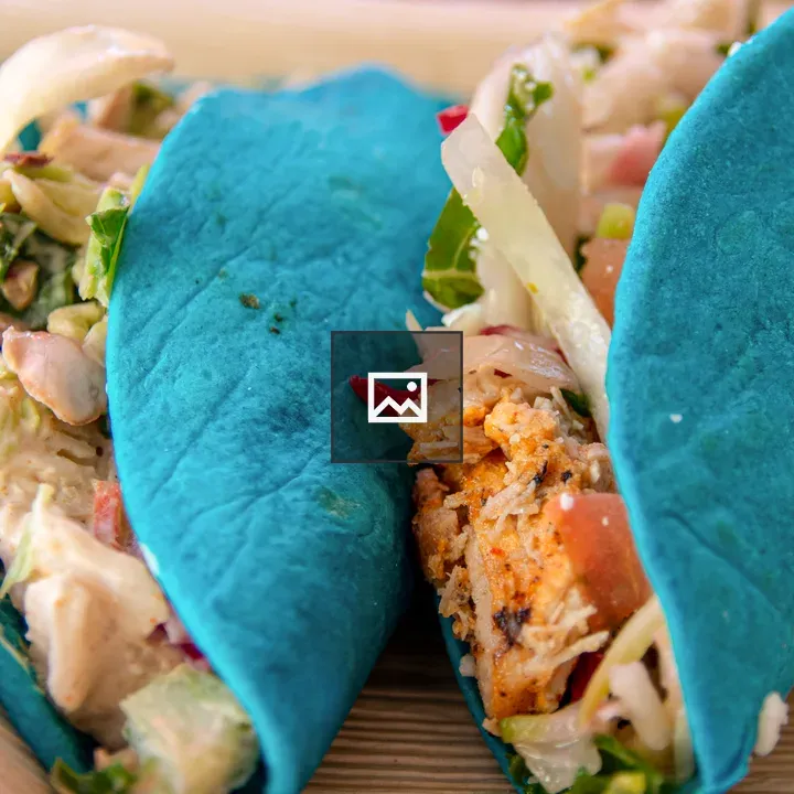 Two tacos with blue shells