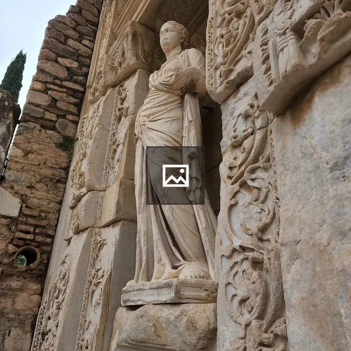 Stone statue in carved wall niche