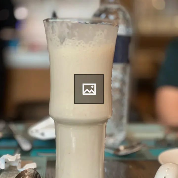 Creamy beverage in tall glass