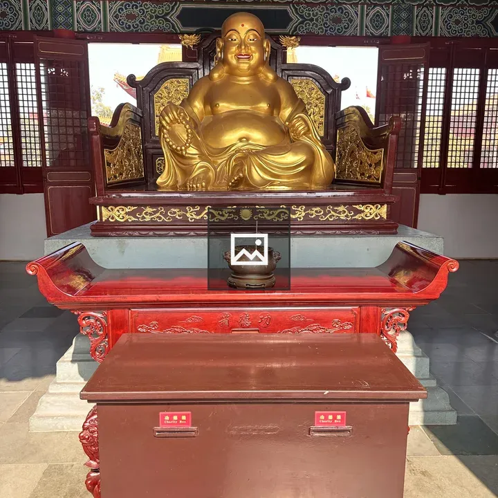 Laughing Buddha Statue on Carved Platform