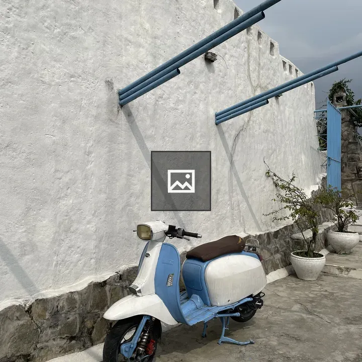 Vintage scooter by white wall