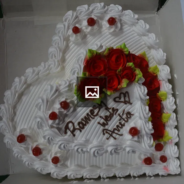 Wedding cake with white heart and red roses