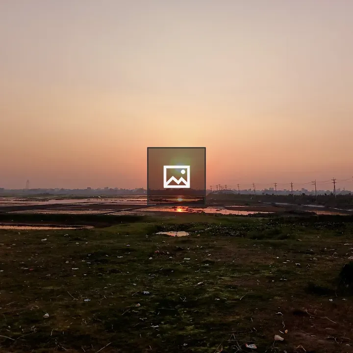 Sunset Over Grass and Water