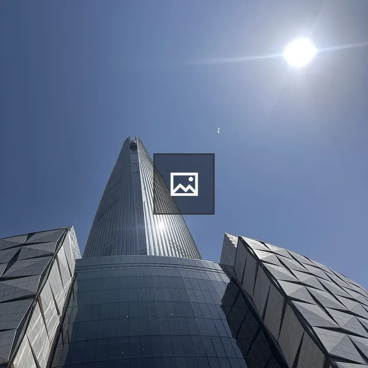 Tall modern skyscraper against blue sky