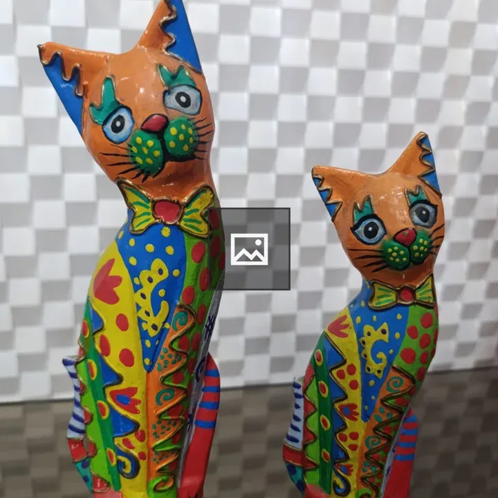 Colorful cat figurines on reflective surface