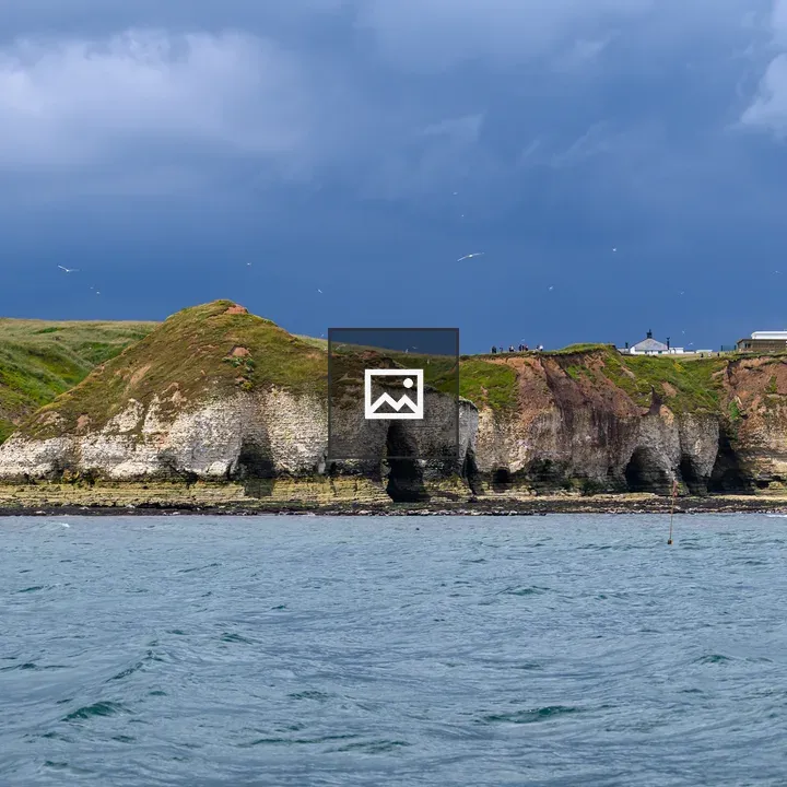 Cliffs and Lighthouse at Sea