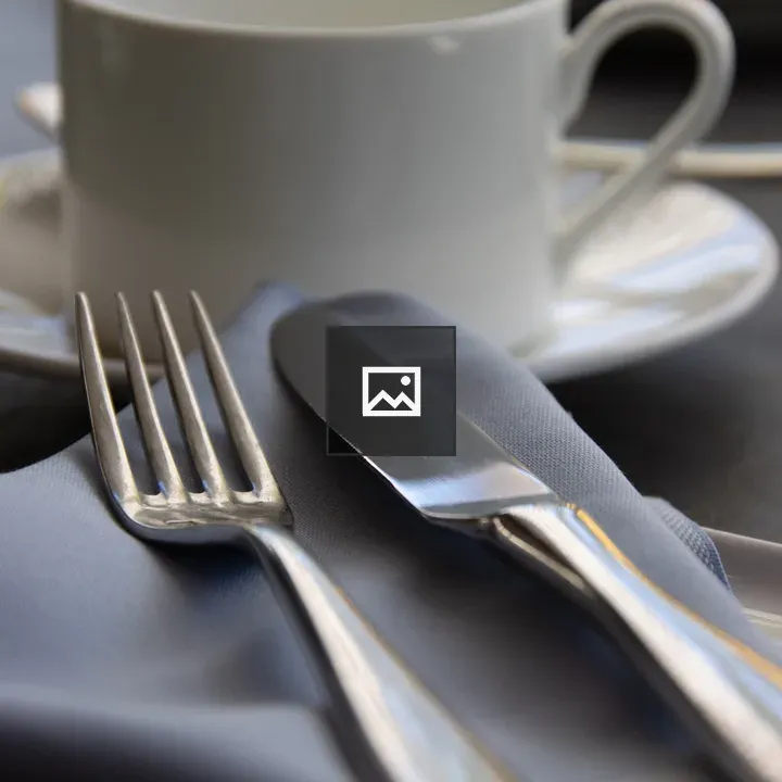 Closeup of Empty Coffee Cup and Utensils