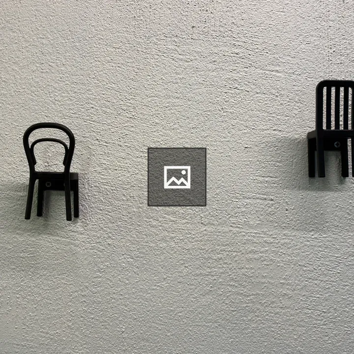 Tiny chairs on wall