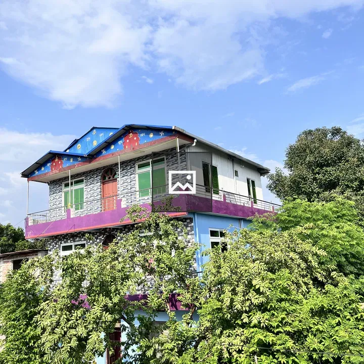 Brightly colored house with blue roof