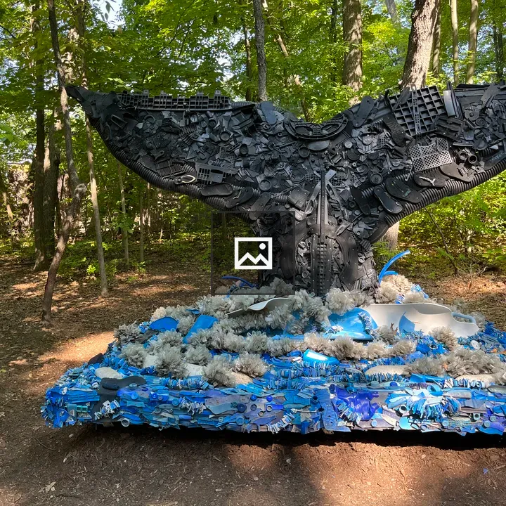 Whale tail sculpture made from trash