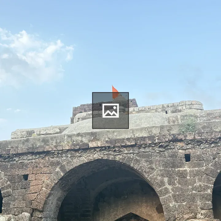 Ancient stone arches with orange flag