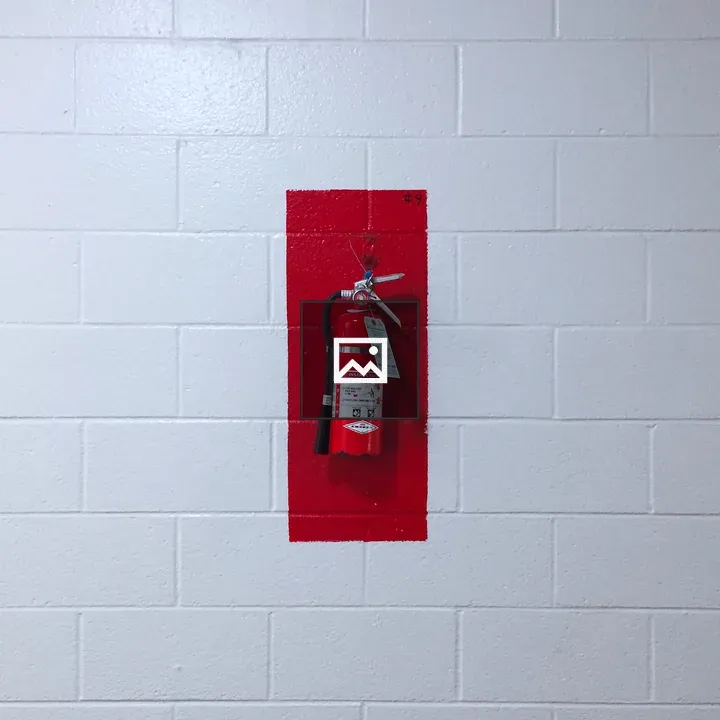 Fire extinguisher on red wall