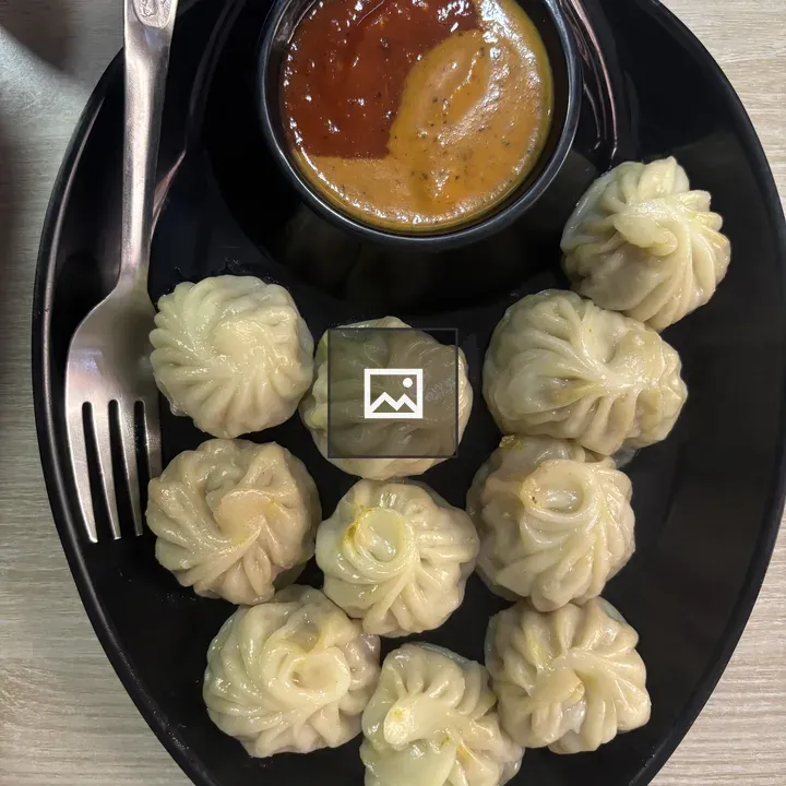 Steamed dumplings on black plate