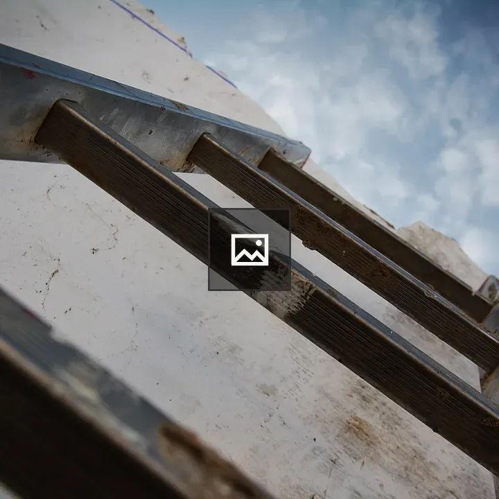 Ladder Against Wall with Sky