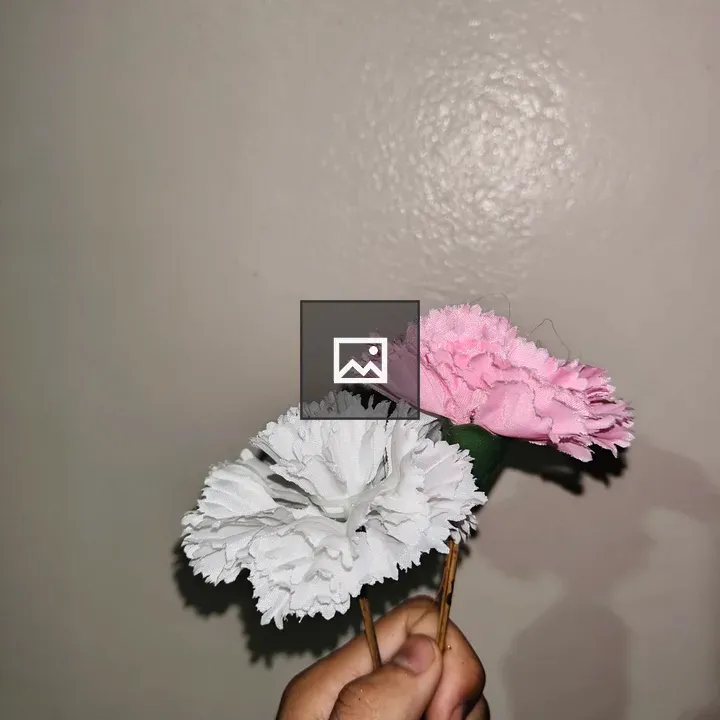 Hand holding artificial flowers