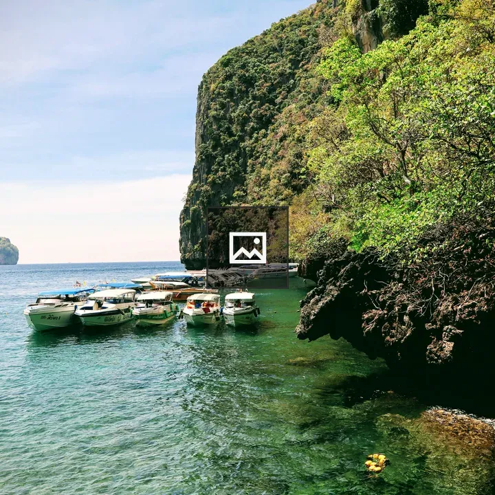 Boats Near Rocky Shore