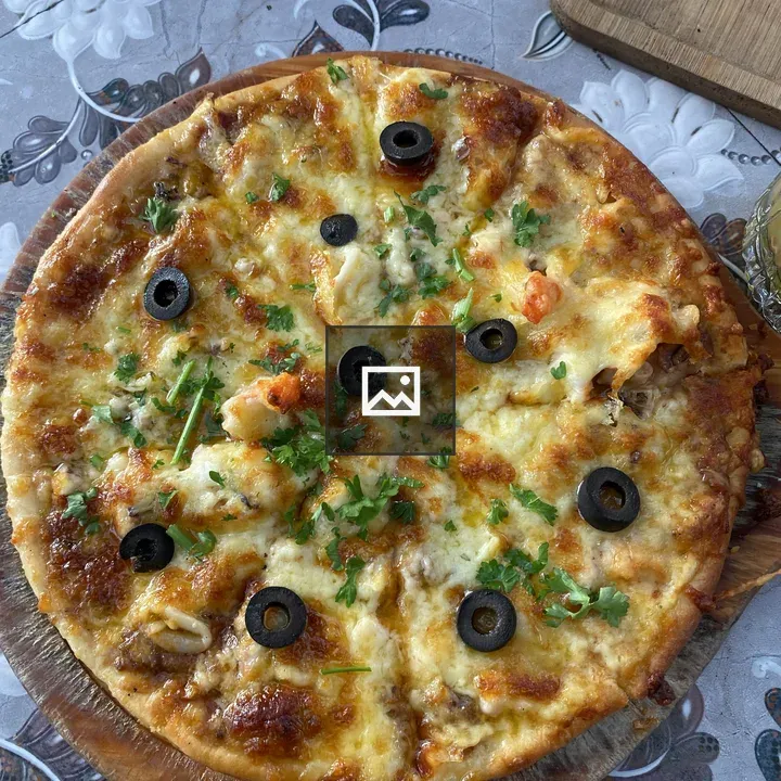 Freshly baked pizza on cutting board