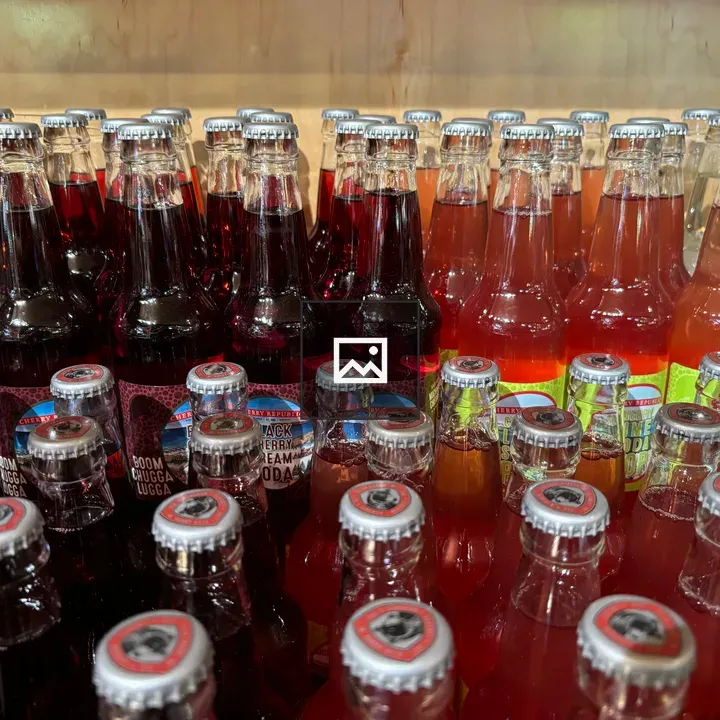 Rows of glass beverage bottles