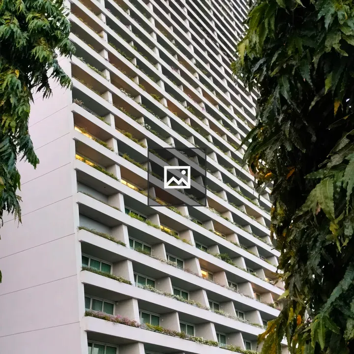 Tall Building with Green Balconies