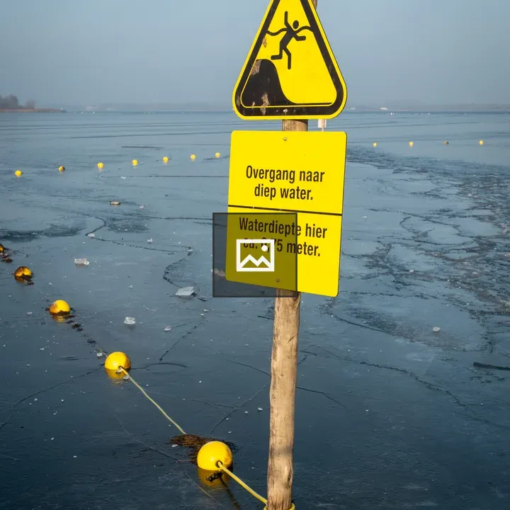 Deep water warning sign on lake