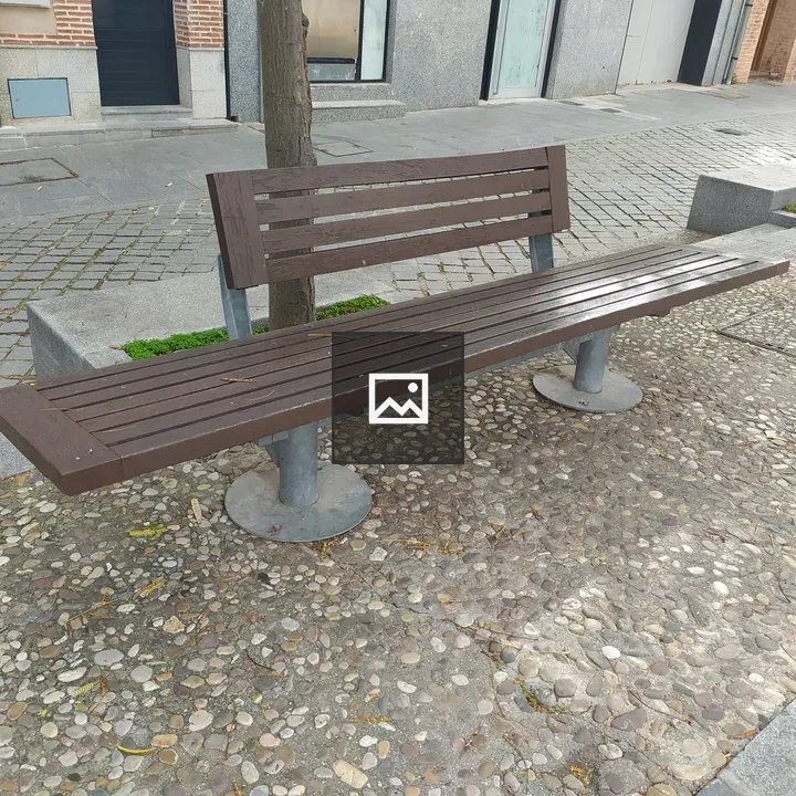 Wooden bench on sidewalk