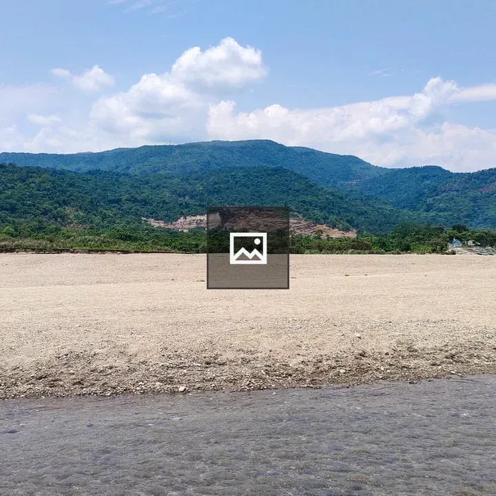 Dry riverbed with green hills