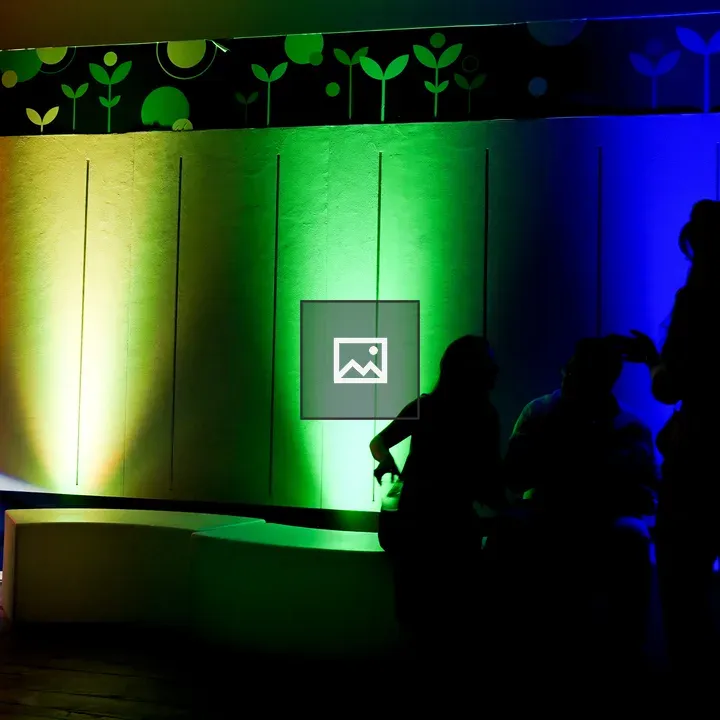 Rainbow wall with silhouetted people