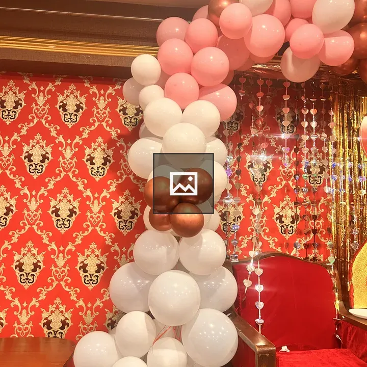 Balloon Arch Over Red Chair