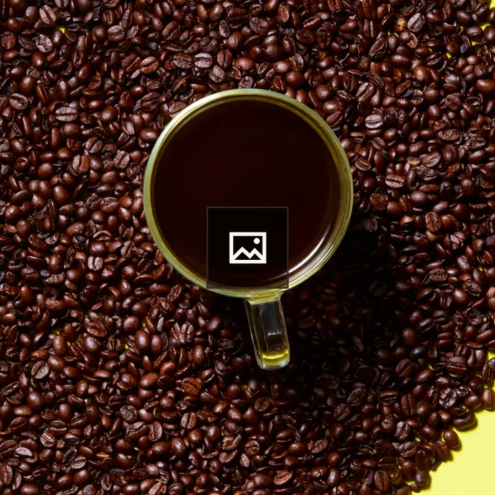 Coffee cup with beans on yellow
