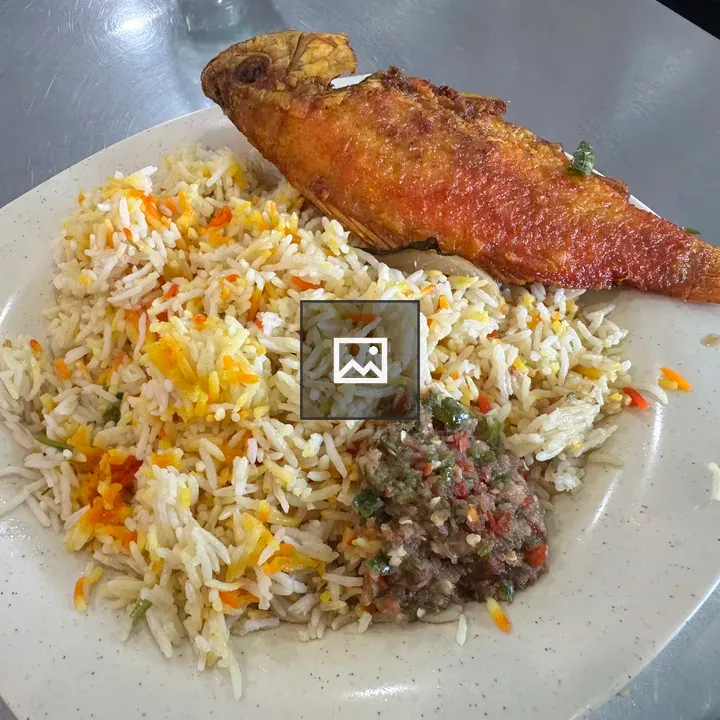Plate of colorful fried fish with rice