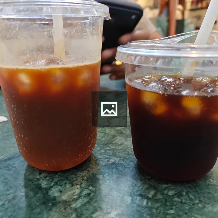 Two iced tea drinks in clear cups