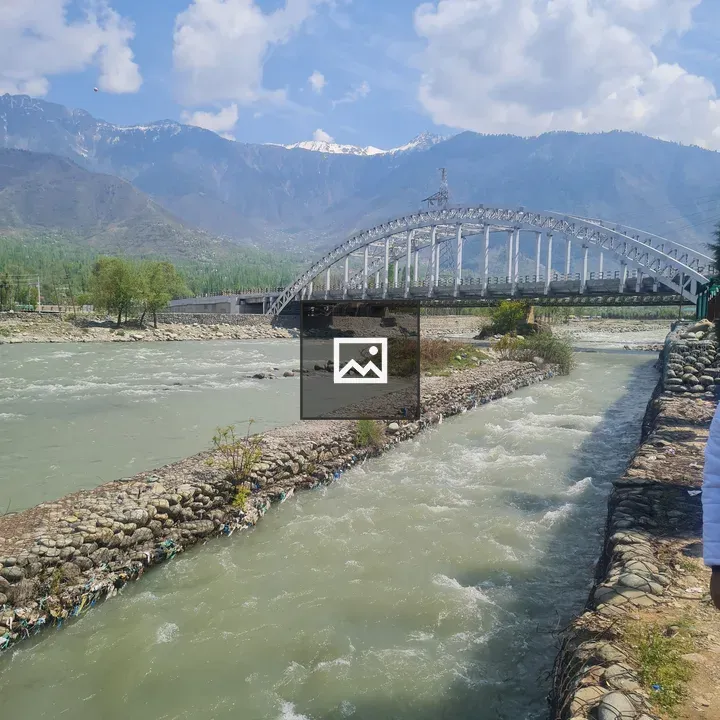 River and Bridge in Mountain Scene