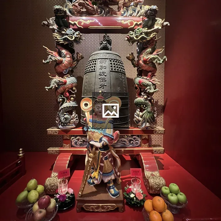 Protective deity statue and temple bell