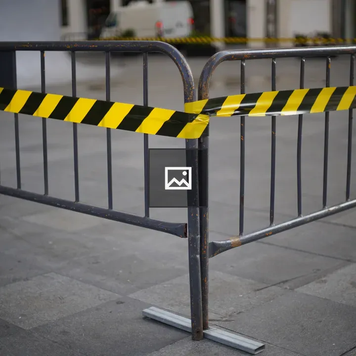 Metal barricade with caution tape