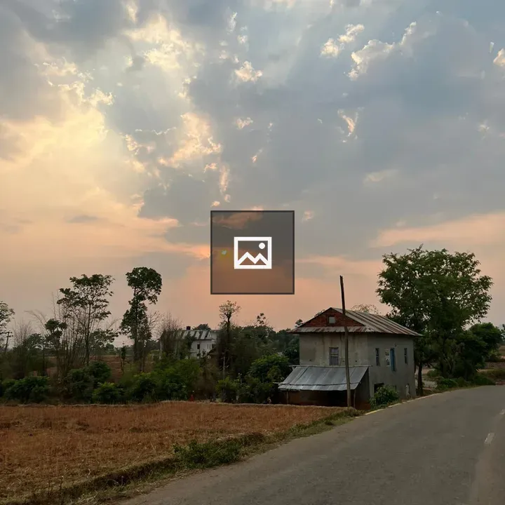 Rural Sunset with Winding Road and House