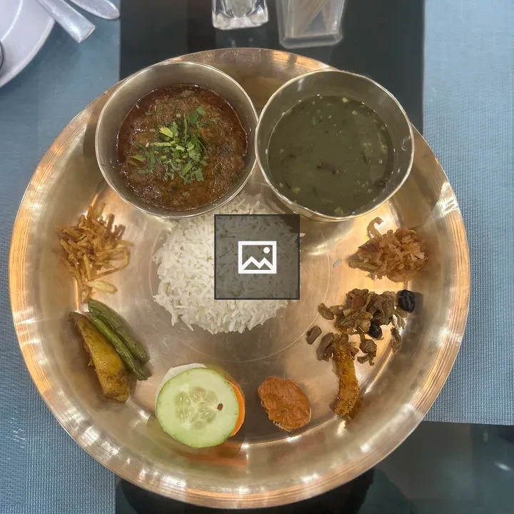 Brass plate with rice and curries