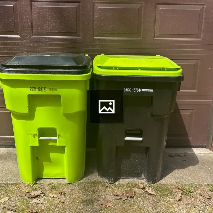 Plastic bins in front of garage