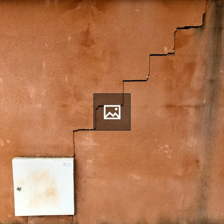 Textured reddish-tan wall with crack
