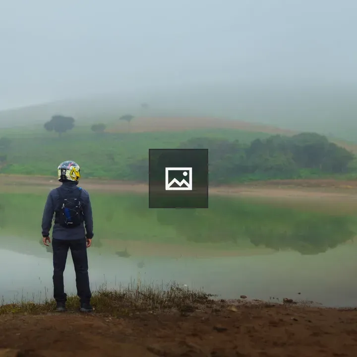 Person on Lakeside Edge with Helmet
