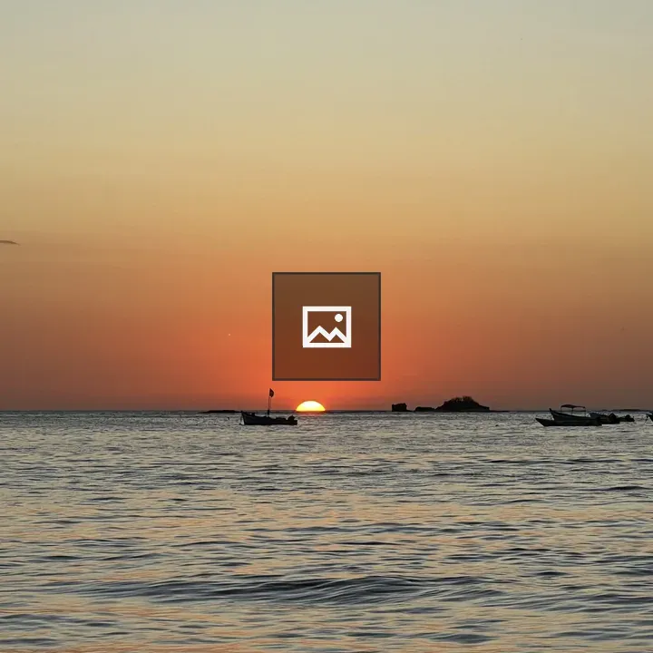 Sunset over calm ocean with waves