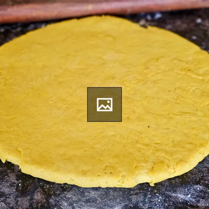 Fresh yellow dough on kitchen surface