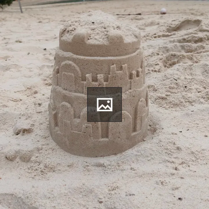 Sandcastle on Beach with Rope Bridge
