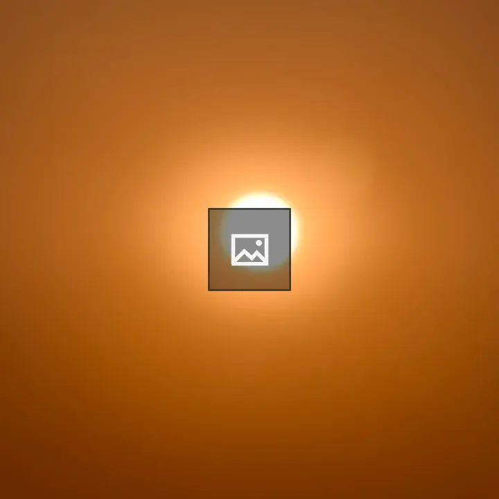 Sun centered over orange sky