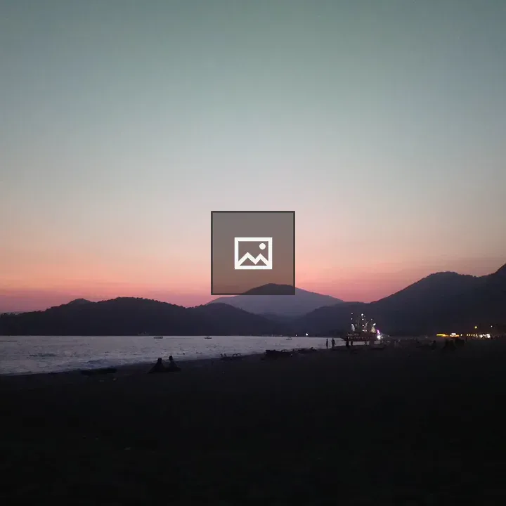 Serene beach at dusk with hills