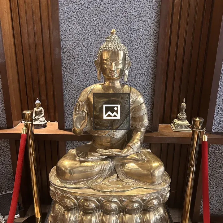 Golden Buddha statue with smaller figures